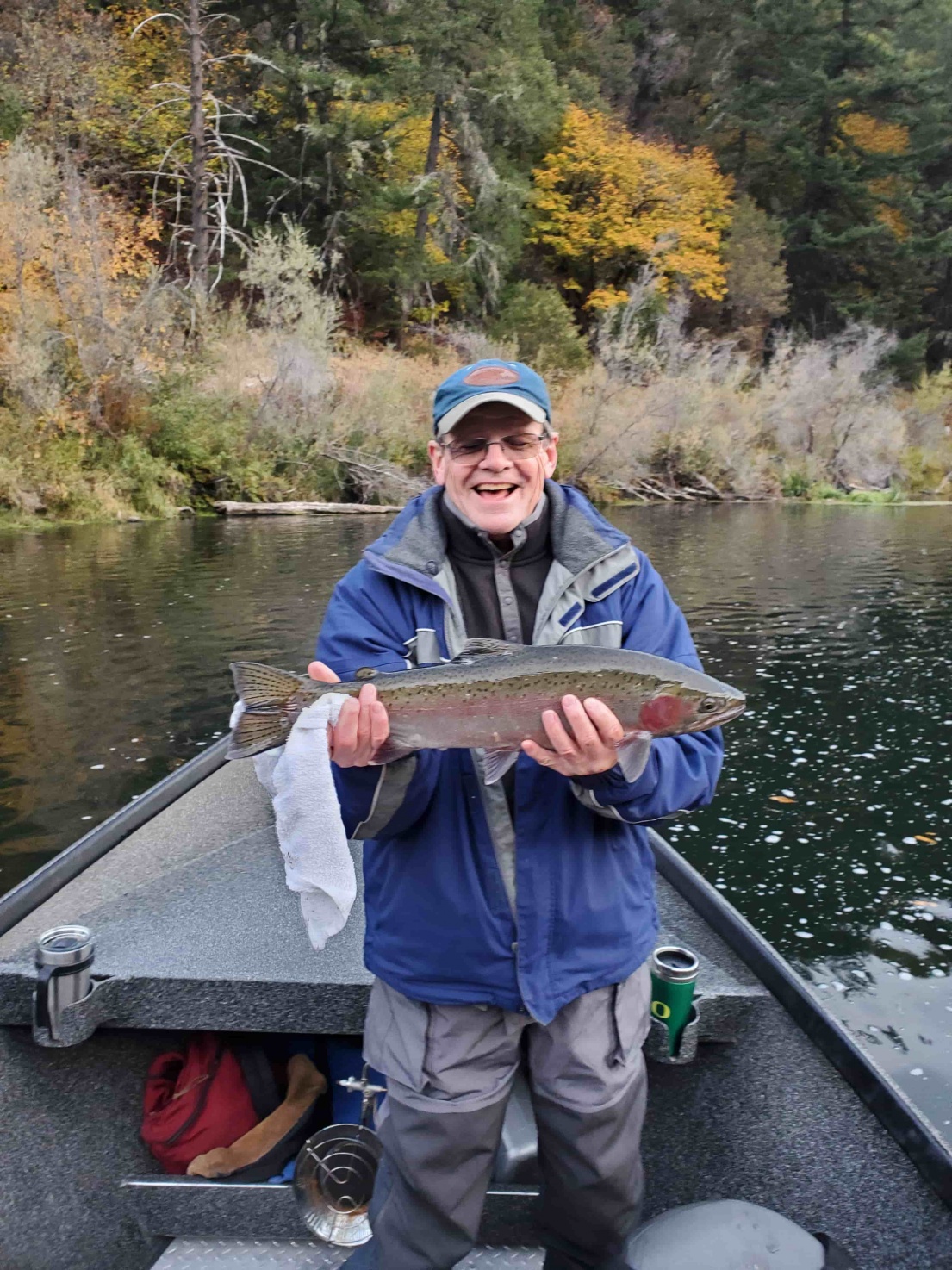 Angler holding a steelhead on the Rogue River